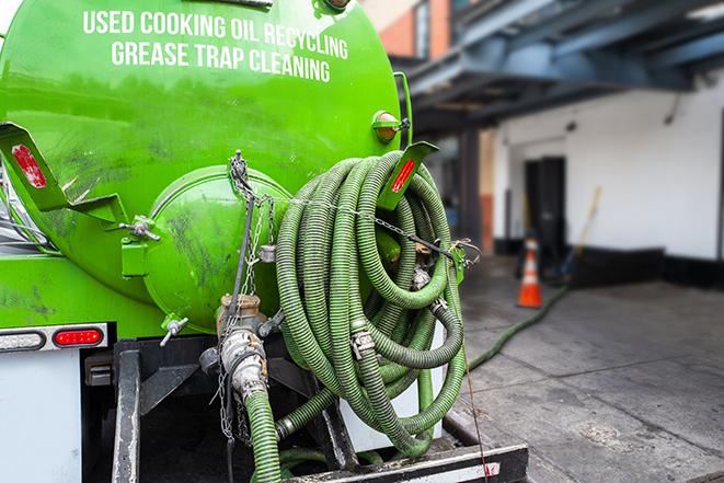 a grease trap being pumped by a sanitation technician in Monroe NY